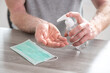 Hand pressing on sanitizer bottle; prevention of virus and bacteria infection