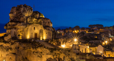 Poster - The Roman Catholic church of Santa Maria de Idris, cut into the rock in Matera at night.