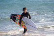 © Jose Prieto - A boy, with its surfboard, is evaluating the surf