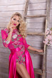 © Fotostudijas.lv - A beautiful blonde in a sexy pink dress on a spring background.