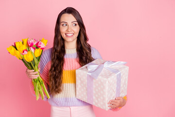 Canvas Print - Portrait of attractive cheerful girl holding in hands tulips giftbox looking aside copy space sale isolated over pink pastel color background