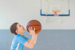 © Augustas Cetkauskas - School kid playing basketball in a physical education lesson. Safe back to school during pandemic concept