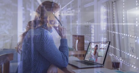 Poster - Spots of light against woman wearing phone headset having a video call on laptop