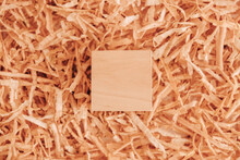 One Wooden Block On A Background Of Carpentry Shavings. Top View. Copy, Empty Space For Text