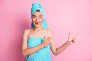 Sticker - Photo of optimistic nice young lady pointing empty space wear teal bath towels on head body isolated on pink color background