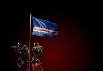 Concept of military conflict. Waving national flag of Cape Verde. Illustration of coup idea. Two soldier statue guards defending the symbol of country against red wall