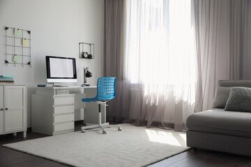 Wall Mural - Comfortable blue chair near desk in stylish office interior