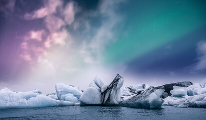 Wall Mural - Northern lights aurora borealis over Jokulsarlon glacier ice lagoon in Iceland