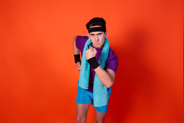 Funny young man and retro style. Sports and recreation. Bright colors. Orange background.