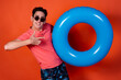 © Denis - Portrait of handsome amazed guy carrying rubber circle pout lips relax isolated over orange color background.