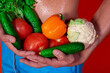 © Denis - A beautiful male body and natural vegetables. Diet and nutrition. Orange background. Broccoli, tomatoes, cucumbers, peppers and lettuce.