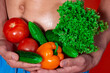 © Denis - A beautiful male body and natural vegetables. Diet and nutrition. Orange background. Broccoli, tomatoes, cucumbers, peppers and lettuce.