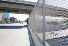 A View Of An Overpass Bridge From A Pedestrian Point Of View. Another Bridge Is Above And A Freeway Is Below.