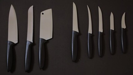 Choosing a kitchen knife on black background seamless looping hand picking knife
