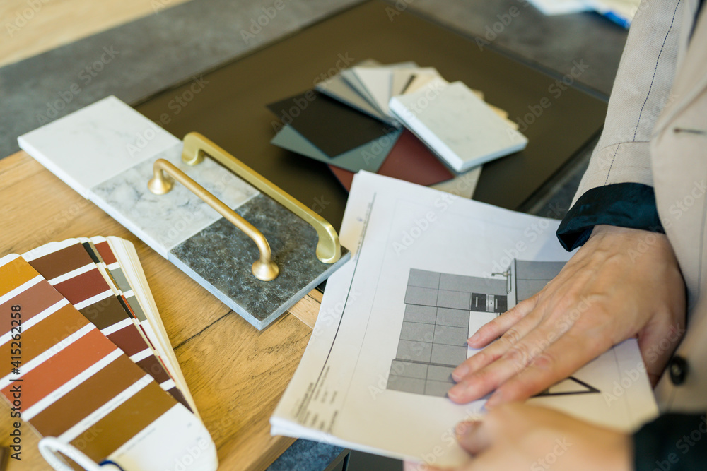 Designer woman choosing details of new kitchen in a home improvement store. Real estate, home renovation, small business concept - obrazy, fototapety, plakaty 