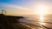 Tracking Bright And Colorful Picturesque Sunset Over Pacific Ocean Along Coastline Cliffs In San Diego, CA 