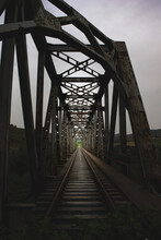 Vertical Shot Of An Interesting Metallic Railroad Bridge Under The Clear Sky