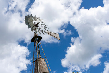 farm windmill with cloudy sky background.