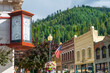 An antique clock showing time and temperature on the corner of a vintage building in the historic mining town of Wallace, Idaho, USA
