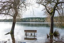 Flooded Park Bench At A Tranquil Lake, Elk Lake Park, Victoria, BC, Canada