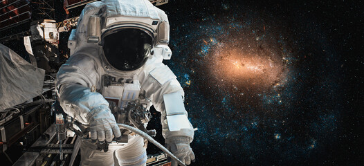 Wall Mural - Astronaut spaceman do spacewalk while working for space station in outer space . Astronaut wear full spacesuit for space operation . Elements of this image furnished by NASA space astronaut photos.