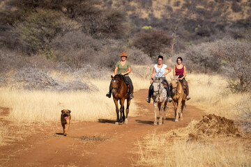 Canvas Print - Three women ride on track with dog