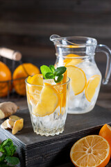 Wall Mural - Lemonade with fresh lemon and mint in glass jug