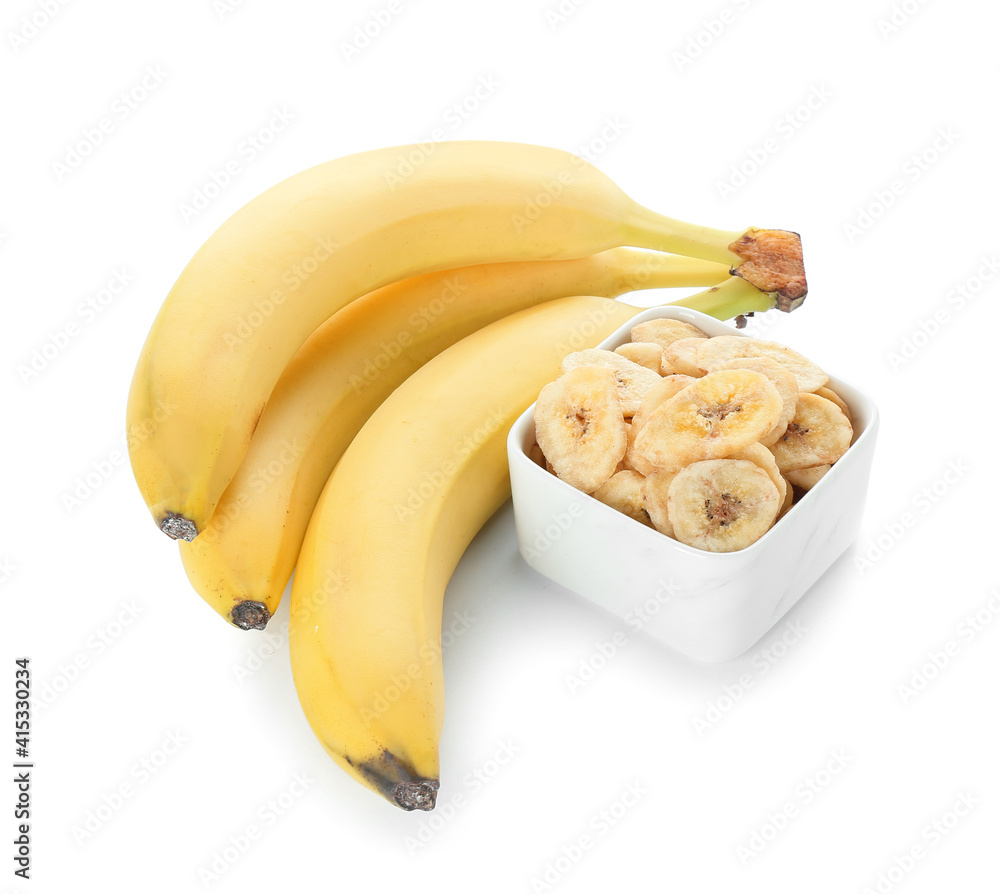 Fresh bananas and chips on white background