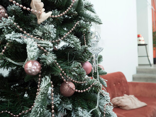 the green branch of the Christmas tree. decorated with snow and Christmas decorations. Close-up.