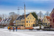 People walking on the frozen canal in the harbor of Dokkum, Netherlands