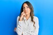© Krakenimages.com - Young brunette woman wearing casual clothes thinking concentrated about doubt with finger on chin and looking up wondering