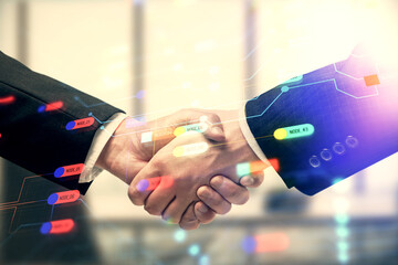 Double exposure of data theme hologram and handshake of two men. Partnership in IT industry concept.