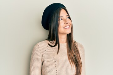 Sticker - Young brunette woman wearing french look with beret looking away to side with smile on face, natural expression. laughing confident.