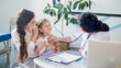 © alex_marina - Female Doctor Pediatrician Using Stethoscope Listen to the Heart of Happy Healthy Cute Kid Girl at Medical Visit With Mother in the Hospital. Female Doctor Examining Child.