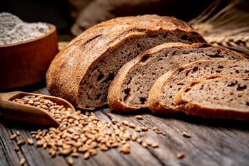 Freshly baked traditional bread on wooden table.