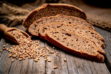 Wall Mural - Freshly baked traditional bread on wooden table.