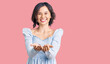© Krakenimages.com - Young beautiful girl wearing casual clothes smiling with hands palms together receiving or giving gesture. hold and protection