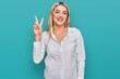 © Krakenimages.com - Young caucasian woman wearing casual clothes showing and pointing up with fingers number two while smiling confident and happy.