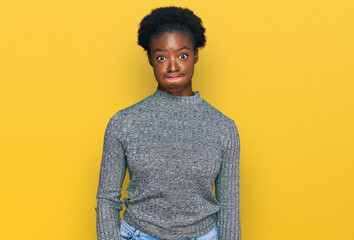 Poster - Young african american girl wearing casual clothes puffing cheeks with funny face. mouth inflated with air, crazy expression.