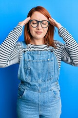 Poster - Beautiful redhead woman wearing casual clothes and glasses with hand on head, headache because stress. suffering migraine.