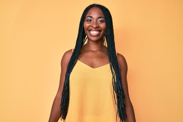 Sticker - African american woman with braids wearing casual clothes with a happy and cool smile on face. lucky person.