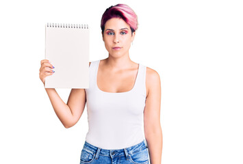 Sticker - Young beautiful woman with pink hair holding notebook thinking attitude and sober expression looking self confident