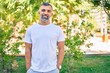 © Krakenimages.com - Middle age grey-haired man smiling happy standing at the park.