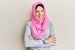 © Krakenimages.com - Young caucasian woman wearing traditional islamic hijab scarf happy face smiling with crossed arms looking at the camera. positive person.