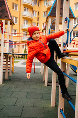 Poster - Boy strengthens his body climbing on outdoor playground