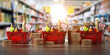 © Maksym Yemelyanov - Growth of food sales or growth of market basket or consumer price index concept. Shopping basket with foods with coin stacks in grocery shop.