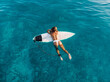 © artifirsov - Attractive surfer woman relaxing on surfboard in ocean. Aerial view with surf girl