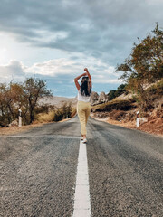 Sticker - Closeup view of a person standing on the empty highway on a sunny summer day