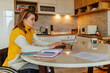 © bernardbodo - Disabled woman working at home with the help of technology