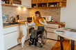 © bernardbodo - Woman in wheelchair playing with cat